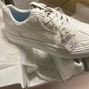 White pair of Tennis Shoes size 9M. Brand is Blowfish Malibu.